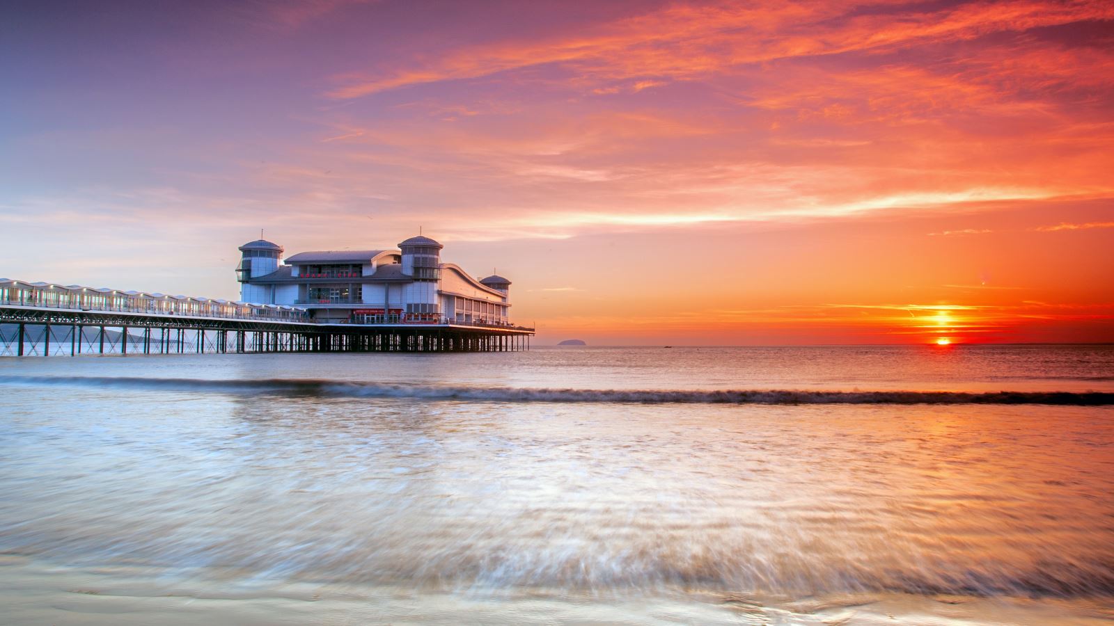 a pier in somerset overlooking a sunset