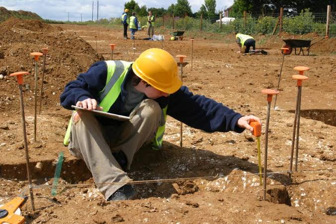 Archaeologist Measuring on a Dig Site workman on an archaeological dig