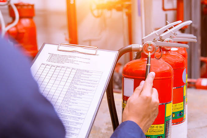 Fire Safety Engineer Checking Extinguisher Pressure. Image