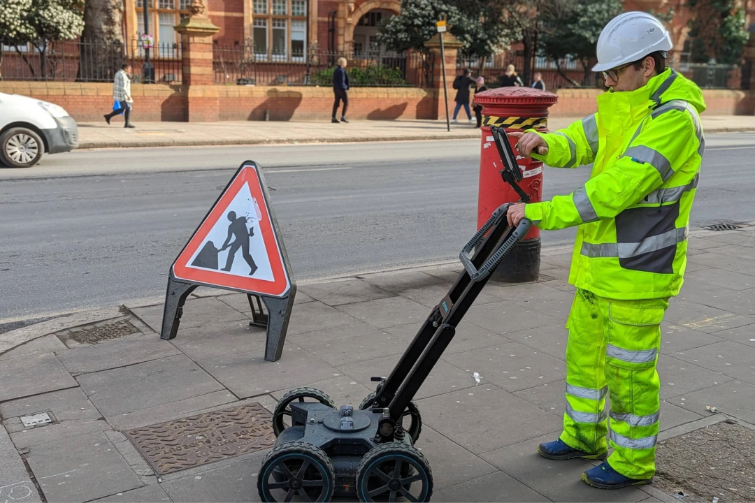 A Survey Engineer using Ground Penetrating Radar Equipment to check for Underground Utilities Image