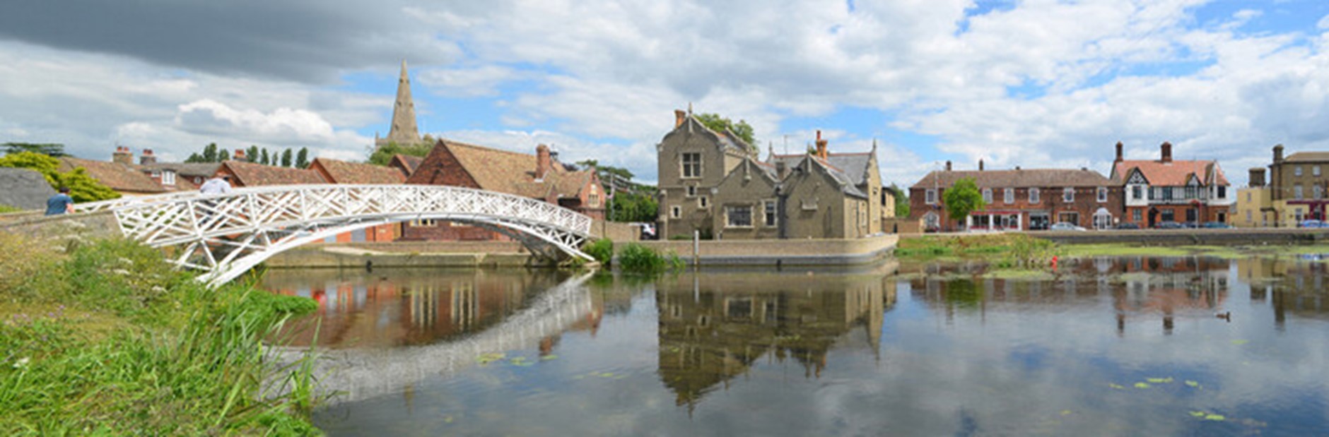 an iron bridge over a peaceful river